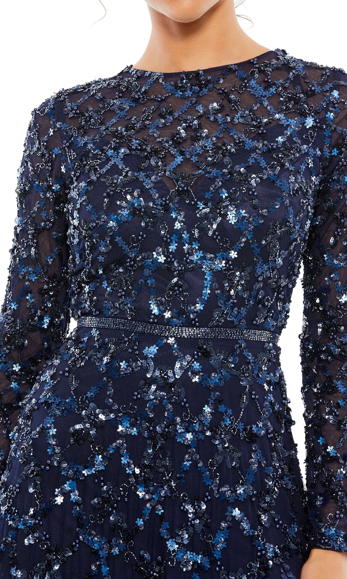Someone wearing the Mac Duggal 5496 Long Sleeve Sequin Formal Gown in navy, featuring floral sequin and beadwork; face partially obscured.